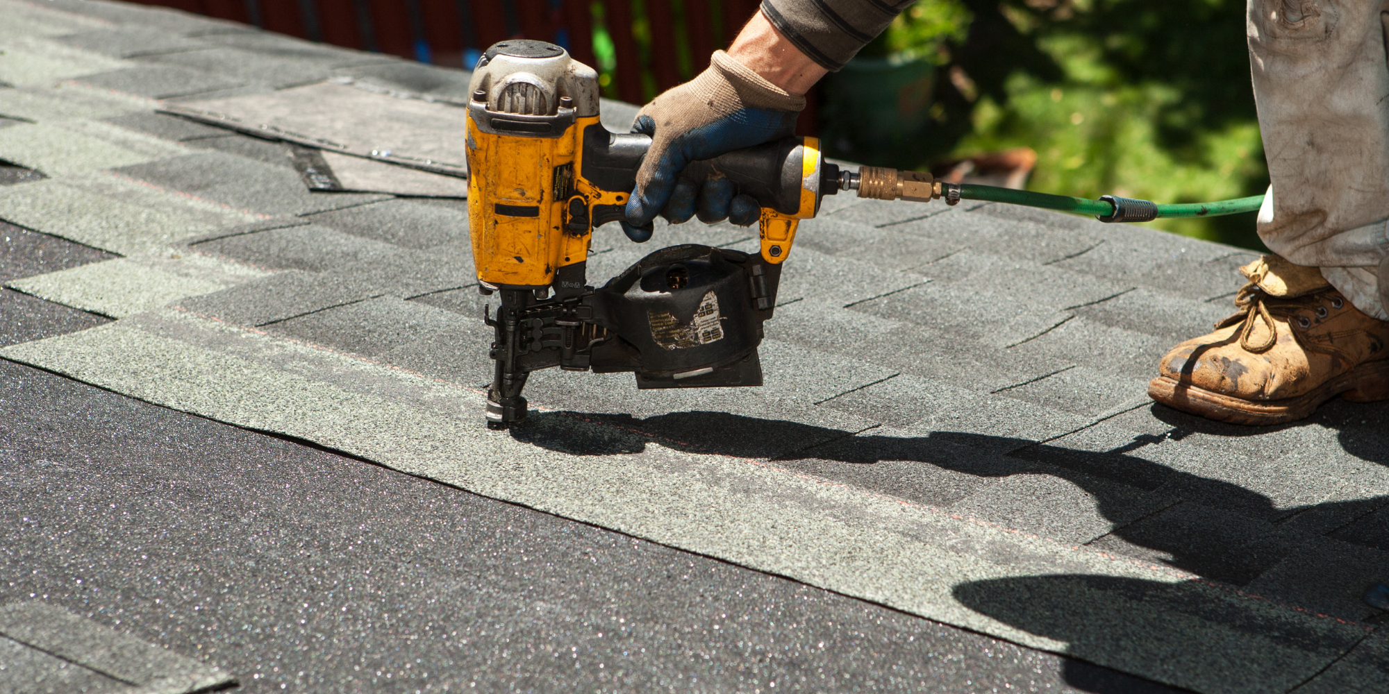 Roofing nailer installing shingles on a residential roof