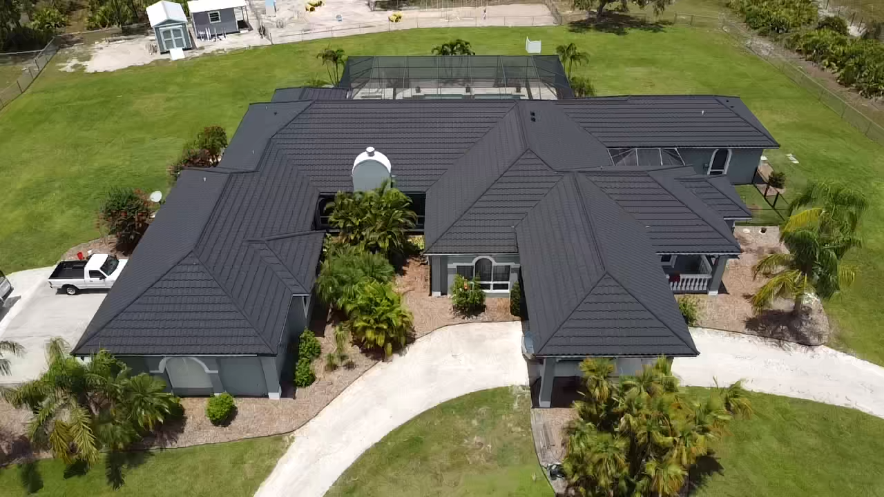 Aerial photo of a completed stone-coated metal roof that has the appearance of tile